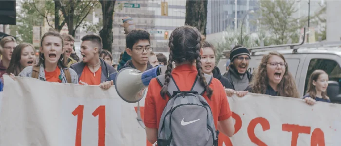 a young person with a bullhorn at a protest